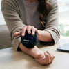 Deep tissue massage ball helping to reduce muscle tension in the back, neck and legs.