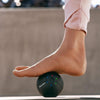 Massage ball for feet and calves providing targeted vibration to tired muscles.