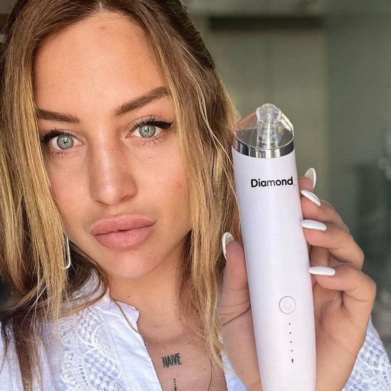 Blackhead removal device with interchangeable suction heads