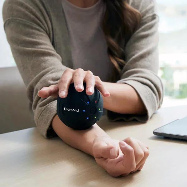 Deep tissue massage ball helping to reduce muscle tension in the back, neck and legs.