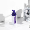 Diamond Smile purple tooth whitening color correction foam against a white background in the bathroom