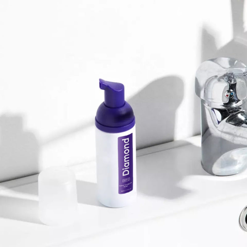 Diamond Smile purple tooth whitening color correction foam against a white background in the bathroom
