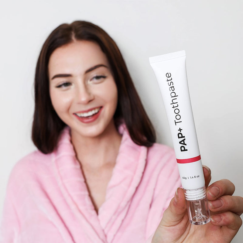 Woman with PAP+ tooth whitening toothpaste from Diamond Smile